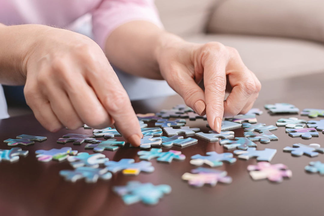 Woman's hands building a jigsaw puzzle